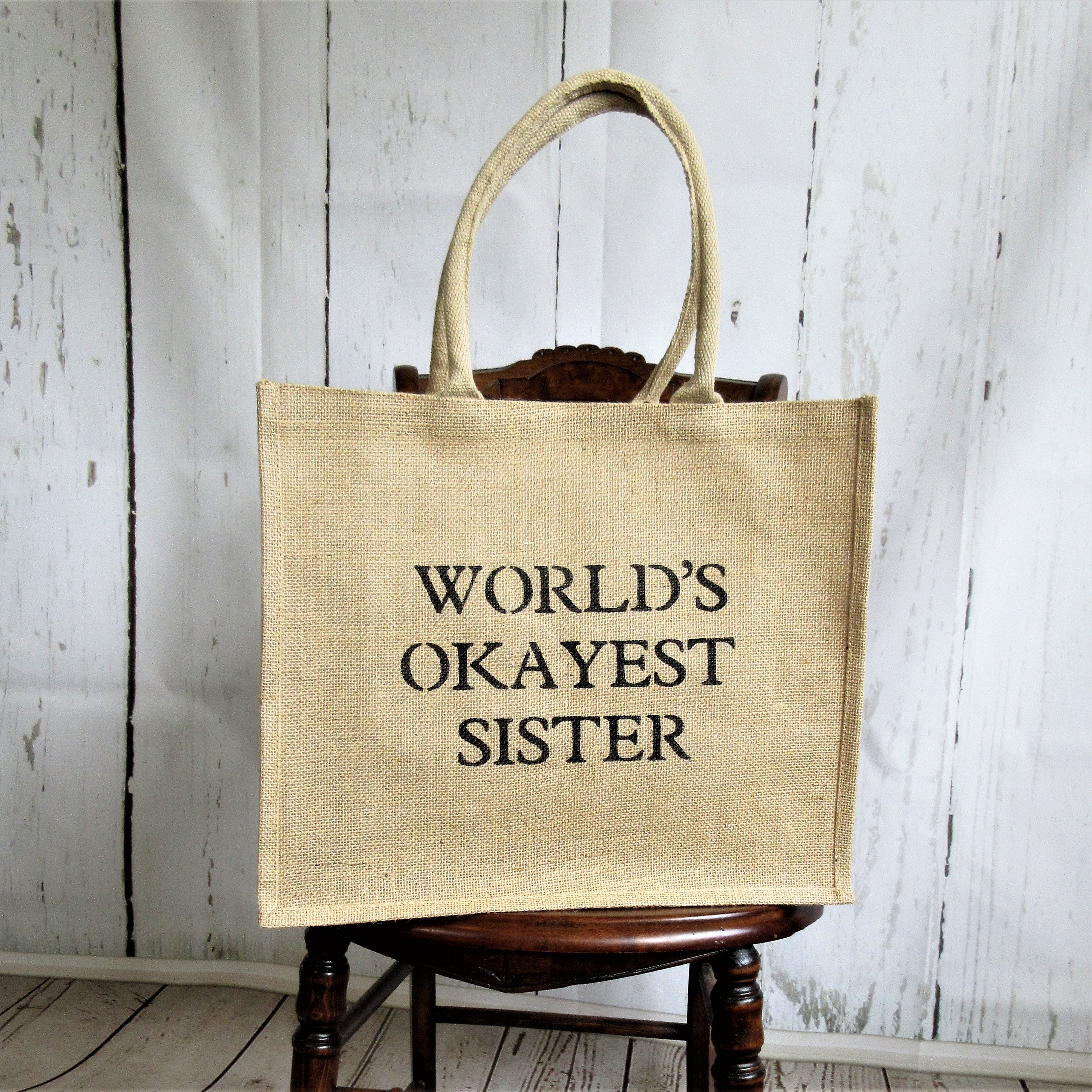 World's Okayest SisterBurlap Tote Bag